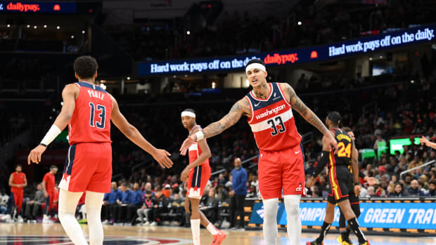 Washington Wizards forward Kyle Kuzma (33) celebrates with guard Jordan Poole (13) during the first half against the Atlanta Hawks at Capital One Arena. 